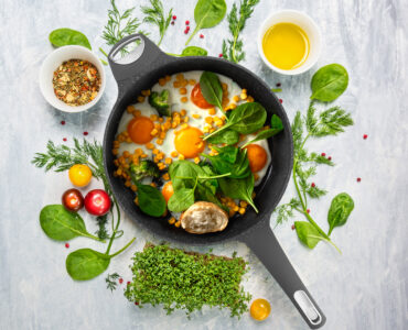 raw salmon in white pan with lemon and fresh herbs, top view
